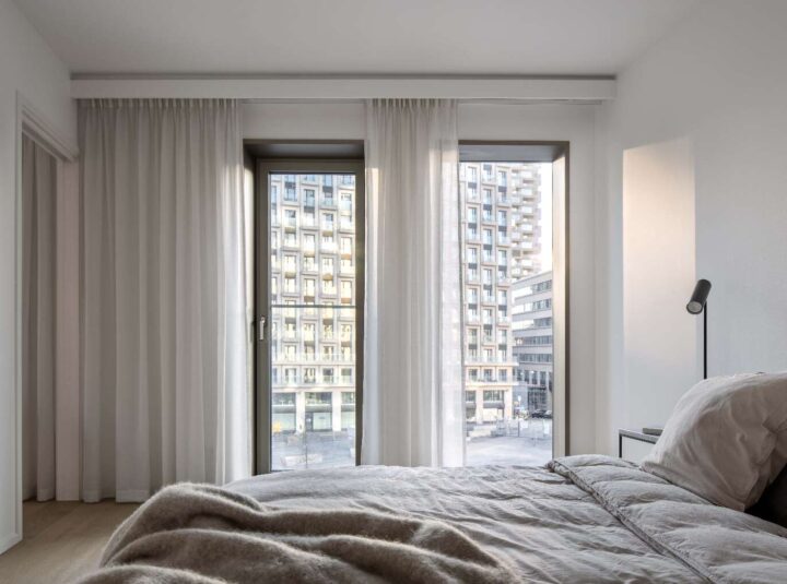 View from two windows with bed in the foreground